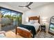 Bedroom with a wooden bed frame and view of landscaped outdoor space at 39912 N 98Th Way, Scottsdale, AZ 85262