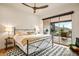 Cozy bedroom with a sliding glass door leading to an outdoor patio at 39912 N 98Th Way, Scottsdale, AZ 85262