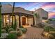 Grand entrance featuring mature desert landscaping and a custom wood door at 39912 N 98Th Way, Scottsdale, AZ 85262