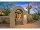 Charming arched entryway with desert landscaping and a brick path leads to the main entrance at 39912 N 98Th Way, Scottsdale, AZ 85262