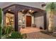 Elegant entryway featuring dark wood beams, custom door and desert landscaping at 39912 N 98Th Way, Scottsdale, AZ 85262