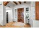 Elegant foyer with a solid wood door, hardwood floors, and charming decor at 39912 N 98Th Way, Scottsdale, AZ 85262