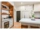 Kitchen area featuring a beverage fridge, wooden shelving, and a quartz countertop island at 39912 N 98Th Way, Scottsdale, AZ 85262