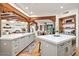 Bright kitchen featuring double islands, quartz countertops, and wood beam accents at 39912 N 98Th Way, Scottsdale, AZ 85262