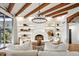 Inviting living room featuring fireplace, built-in shelves, and wood beam ceilings at 39912 N 98Th Way, Scottsdale, AZ 85262