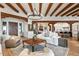 Spacious living room featuring wood beam ceilings, chandelier, and open floor plan at 39912 N 98Th Way, Scottsdale, AZ 85262