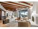 Bright, open living area with wood beams, fireplace, and seamless outdoor access at 39912 N 98Th Way, Scottsdale, AZ 85262