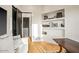Bright living room boasts a white sofa, hardwood floors, and built-in shelving perfect for décor at 39912 N 98Th Way, Scottsdale, AZ 85262