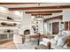 Comfortable living room with fireplace, custom built-ins, and wood-beam ceilings at 39912 N 98Th Way, Scottsdale, AZ 85262