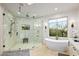 Main bathroom with soaking tub, large walk-in shower, and marble tile at 39912 N 98Th Way, Scottsdale, AZ 85262