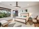 Bright bedroom with a king bed, stylish rug, and door leading to the patio at 39912 N 98Th Way, Scottsdale, AZ 85262