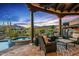 Covered patio features comfortable seating, a spa, and stunning desert views for relaxing and entertaining at 39912 N 98Th Way, Scottsdale, AZ 85262