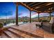 Spacious covered patio with tile flooring, comfortable seating, and steps leading to a pool and desert landscape at 39912 N 98Th Way, Scottsdale, AZ 85262