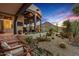 Inviting covered patio with desert landscaping featuring an outdoor television and scenic mountain views at 39912 N 98Th Way, Scottsdale, AZ 85262