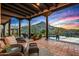 Outdoor patio featuring stunning views, a covered area with comfortable seating, and a pool with desert landscaping at 39912 N 98Th Way, Scottsdale, AZ 85262