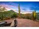 Desert landscaping and seating area with mountain views in the background. Perfect for outdoor living at 39912 N 98Th Way, Scottsdale, AZ 85262