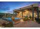 A luxurious backyard featuring a pool, covered patio, desert landscaping, and comfortable seating, perfect for entertaining at 39912 N 98Th Way, Scottsdale, AZ 85262