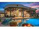 Inviting outdoor living space with pool, hot tub, covered patio, and lush desert landscaping at 39912 N 98Th Way, Scottsdale, AZ 85262