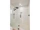 Walk-in shower with white tile, glass door, and modern fixtures at 39912 N 98Th Way, Scottsdale, AZ 85262