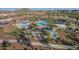 Aerial view of a community pool area with lounge chairs and shaded seating, perfect for outdoor fun at 4013 N Founder Cir, Buckeye, AZ 85396