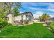 Backyard featuring green grass and manicured landscaping at 4013 N Founder Cir, Buckeye, AZ 85396