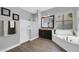A bathroom boasts a soaking tub, separate shower, dark cabinets, and wood-look tile flooring at 4013 N Founder Cir, Buckeye, AZ 85396