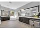 Bathroom featuring double vanity sinks, soaker tub, and wood-style floors at 4013 N Founder Cir, Buckeye, AZ 85396