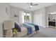Bright bedroom with ample sunlight, a ceiling fan, and closet access to the bathroom at 4013 N Founder Cir, Buckeye, AZ 85396