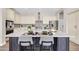 Stylish kitchen island featuring a marble countertop and seating at 4013 N Founder Cir, Buckeye, AZ 85396