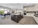 Open-concept kitchen with a dark-wood island, stainless appliances, and seamless access to dining area at 4013 N Founder Cir, Buckeye, AZ 85396