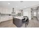 Bright, open kitchen featuring an island with bar seating and modern appliances at 4013 N Founder Cir, Buckeye, AZ 85396