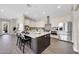 Spacious kitchen with stainless steel appliances, white cabinets and a large center island at 4013 N Founder Cir, Buckeye, AZ 85396