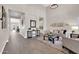 Elegant living room with open floor plan, hardwood floors, and views to kitchen at 4013 N Founder Cir, Buckeye, AZ 85396