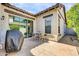 Inviting patio space with a small table, chairs, and BBQ, perfect for outdoor dining and relaxing at 4013 N Founder Cir, Buckeye, AZ 85396
