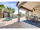 Outdoor covered patio with a ceiling fan and an adjacent pool with a spa at 4013 N Founder Cir, Buckeye, AZ 85396