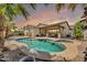 Backyard with a pool and covered patio, perfect for outdoor entertaining and relaxation at 4013 N Founder Cir, Buckeye, AZ 85396