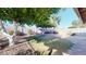 A charming backyard featuring lush greenery, mature trees, and a well-maintained lawn, perfect for outdoor relaxation at 4014 W Anderson Dr, Glendale, AZ 85308