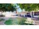 A charming backyard with mature trees, a covered patio, and lush landscaping, creating a tranquil outdoor living space at 4014 W Anderson Dr, Glendale, AZ 85308