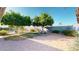 A well-maintained backyard features mature trees, a lush lawn, and a paved patio area, ideal for outdoor gatherings at 4014 W Anderson Dr, Glendale, AZ 85308