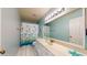 The bathroom features a stylish vanity, bright lighting, and a charming fish-themed shower curtain at 4014 W Anderson Dr, Glendale, AZ 85308