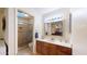Bathroom with tiled shower, neutral colors, and wood vanity at 4014 W Anderson Dr, Glendale, AZ 85308
