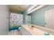 The bathroom features a vanity, bright lighting, and a charming fish-themed shower curtain at 4014 W Anderson Dr, Glendale, AZ 85308