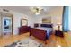 Bedroom featuring a queen-sized bed, wood floors, and ample natural light at 4014 W Anderson Dr, Glendale, AZ 85308