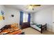 This bedroom features two beds, a dresser, a window with blinds, and various stuffed animals at 4014 W Anderson Dr, Glendale, AZ 85308