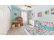 Bright bedroom featuring a ceiling fan, a window with pink curtains, and colorful decorations at 4014 W Anderson Dr, Glendale, AZ 85308