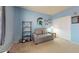 Cozy bedroom with a gray loveseat and a small bookcase at 4014 W Anderson Dr, Glendale, AZ 85308