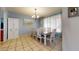 Spacious dining room with tile flooring, ample seating and a traditional chandelier at 4014 W Anderson Dr, Glendale, AZ 85308