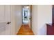 Hallway with hardwood floors, white walls, and doorways leading to other rooms at 4014 W Anderson Dr, Glendale, AZ 85308