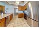 Well-lit kitchen with stainless steel refrigerator and lots of cabinet space at 4014 W Anderson Dr, Glendale, AZ 85308
