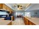 Open kitchen features stainless steel appliances, tile floors, and views to the dining and living area at 4014 W Anderson Dr, Glendale, AZ 85308